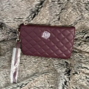 Plum color Badgley Mischka handheld purse with wristband